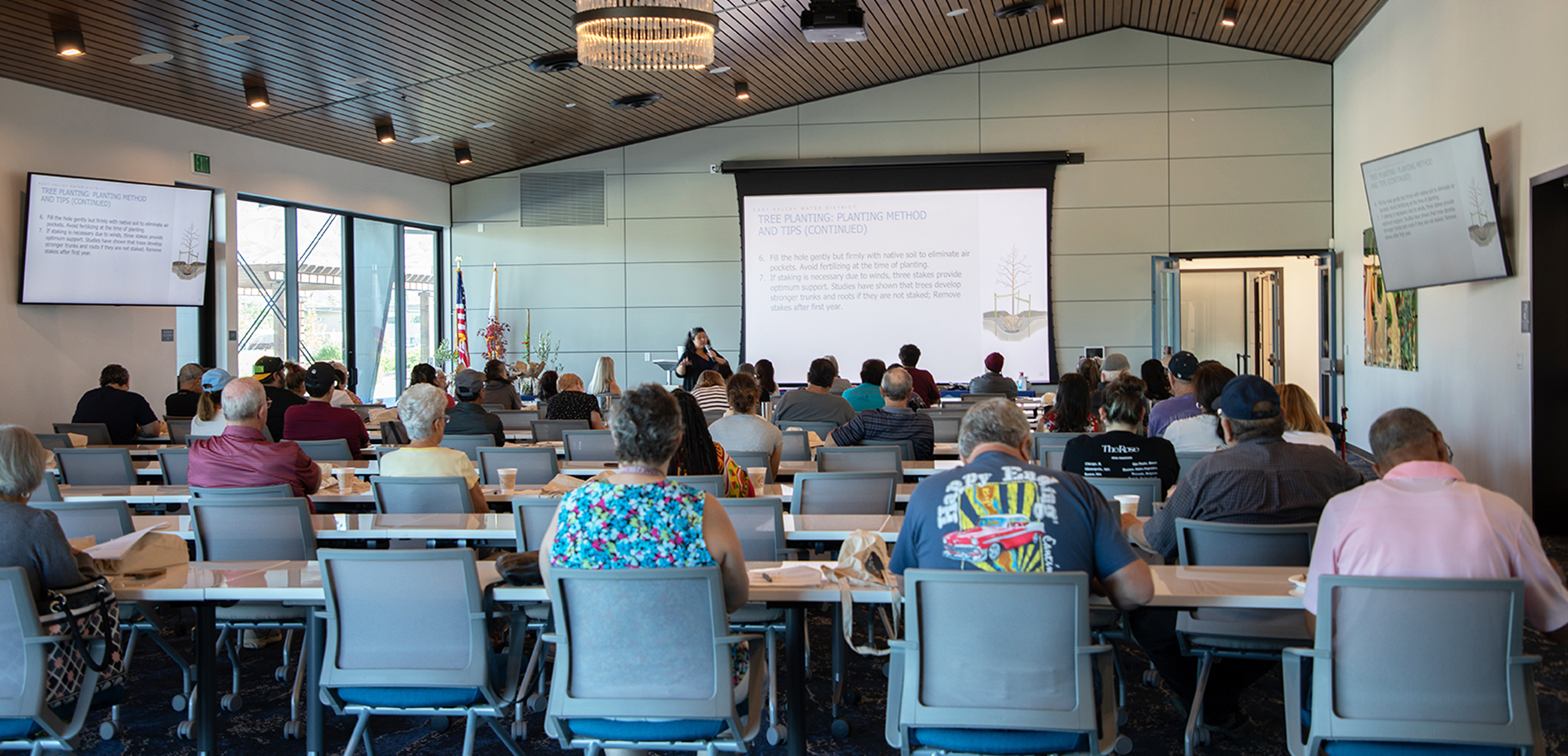 Woman presenting to a group of people 