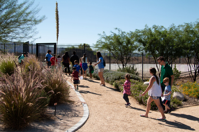 Individuals taking a tour of the demonstration garden