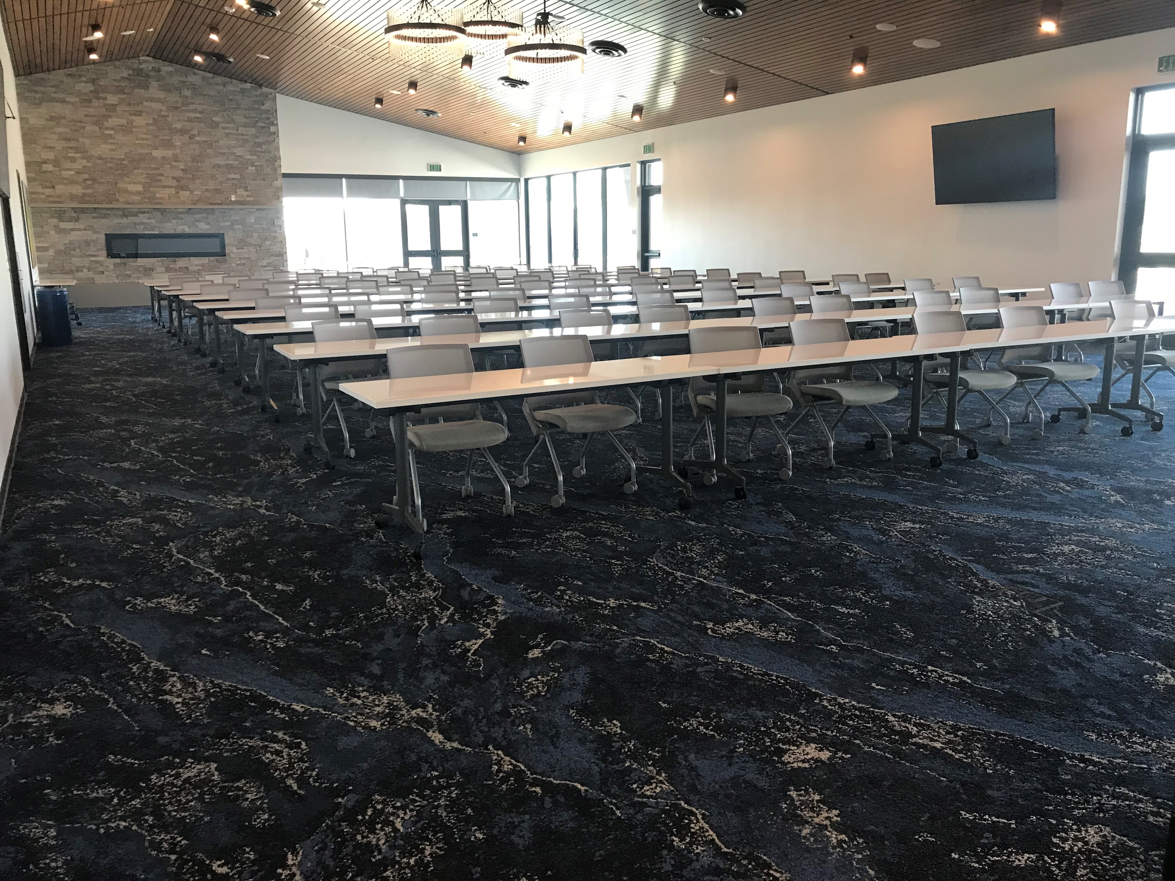 banquet hall set up with seminar tables in a row